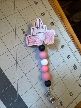 CHANEL Pink Black White Beaded  Badge Reel with Shopping Bag Charm